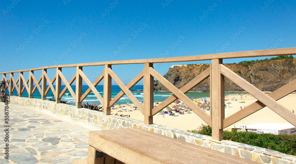 Bridge street and a picturesque view of the beach through a wooden fence. Atlantic ocean, banner.