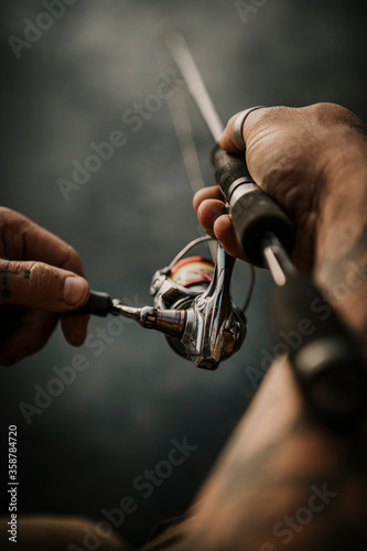 Close up of man holding fishing rod