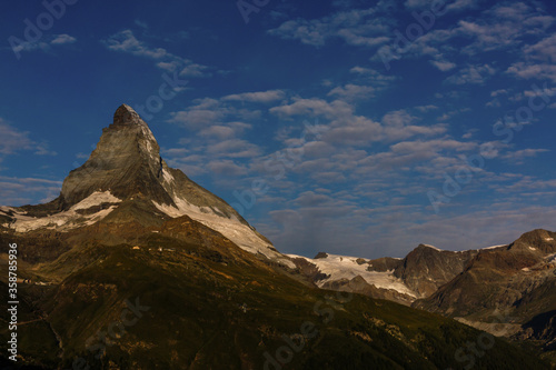 Zermatt, Switzerland. Matterhorn mountain near Grindjisee Lake with flowers in the foreground. Canton of Valais. photo