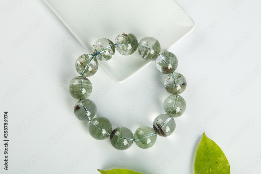 gem bracelet in front of white background
gem bracelet in front of white background