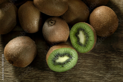 Fresh biologic Kiwi fruit on a wooden table.