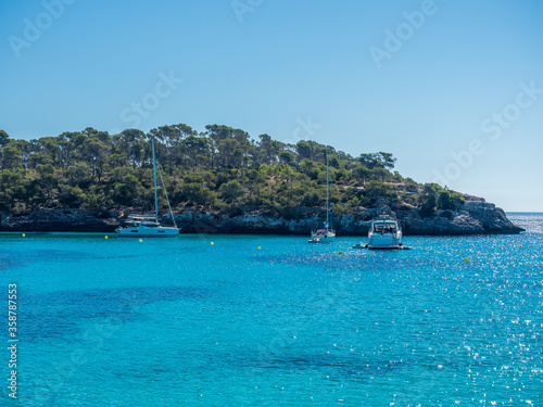 boats anchored off the coast at Cala Mondrago Mallorca Spain 