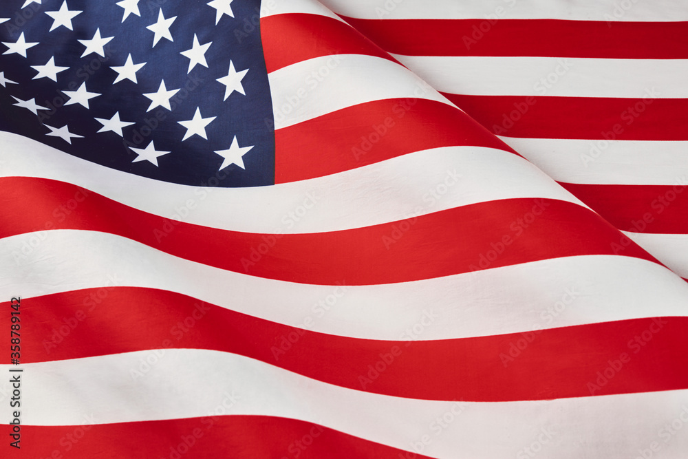 Close up of ruffled American flag. Satin texture curved flag of USA. Memorial Day or 4th of July. Banner, freedom concept Close up of ruffled American flag. Satin texture curved flag of USA. Memorial Day or 4th of July. Banner, freedom concept
