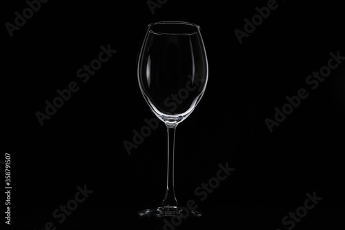 Empty glass for water, juice or milk on a dark background. Symbol of thirst. Close up.