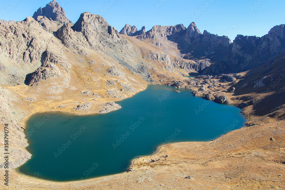 mountain top on a lake and blue sky

