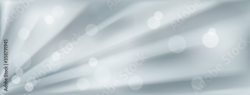 Abstract background with radial rays or folds and bokeh effects in gray colors