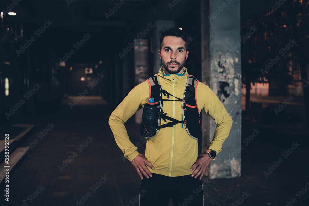 Night city fitness. Good looking man jogging on street. Night city fitness. Good looking man jogging on street.
