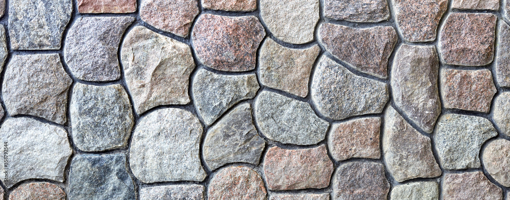 Natural rock wall texture and pattern. A surface or structure made of stone blocks. Natural rock wall texture and pattern. A surface or structure made of stone blocks.