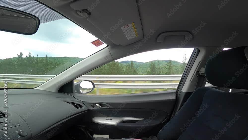 Green landscape view from right window while driving a car on a highway Green landscape view from right window while driving a car on a highway