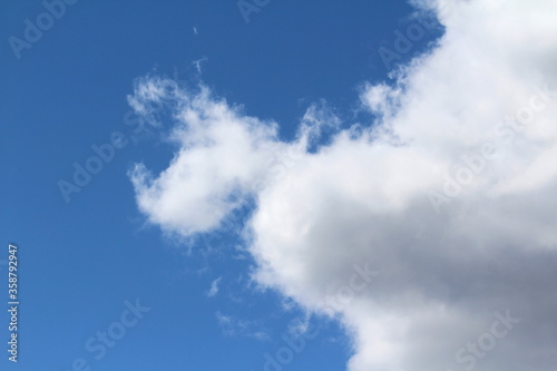 Fototapeta Naklejka Na Ścianę i Meble -  White fluffy clouds on a background of blue sky in summer. The concept of weather and climate