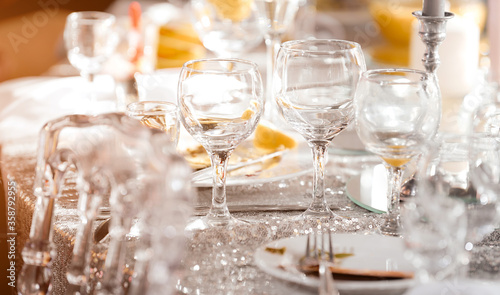 Beautiful festive table of luxury plates, glasses and cutlery served for wine tasting. Close up, blur background.