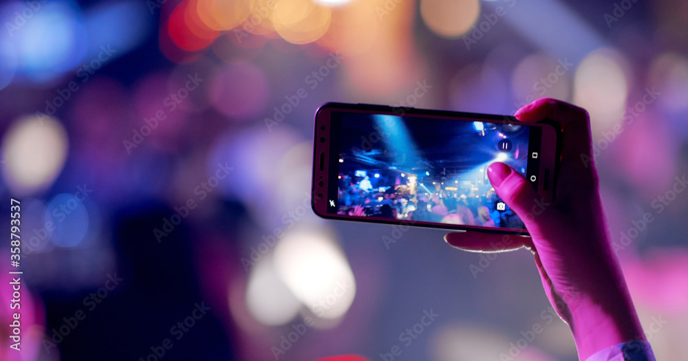 Hands silhouette recording video of live music concert with smartphone. Hands silhouette recording video of live music concert with smartphone.