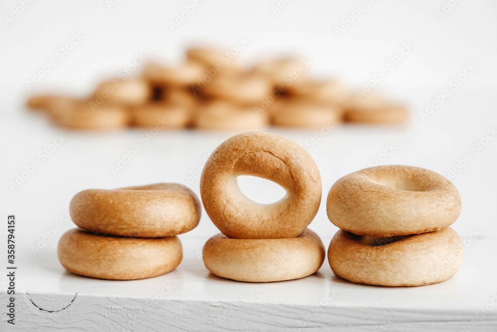 Drying or mini round bagels on a white wooden background. Copy, empty space for text