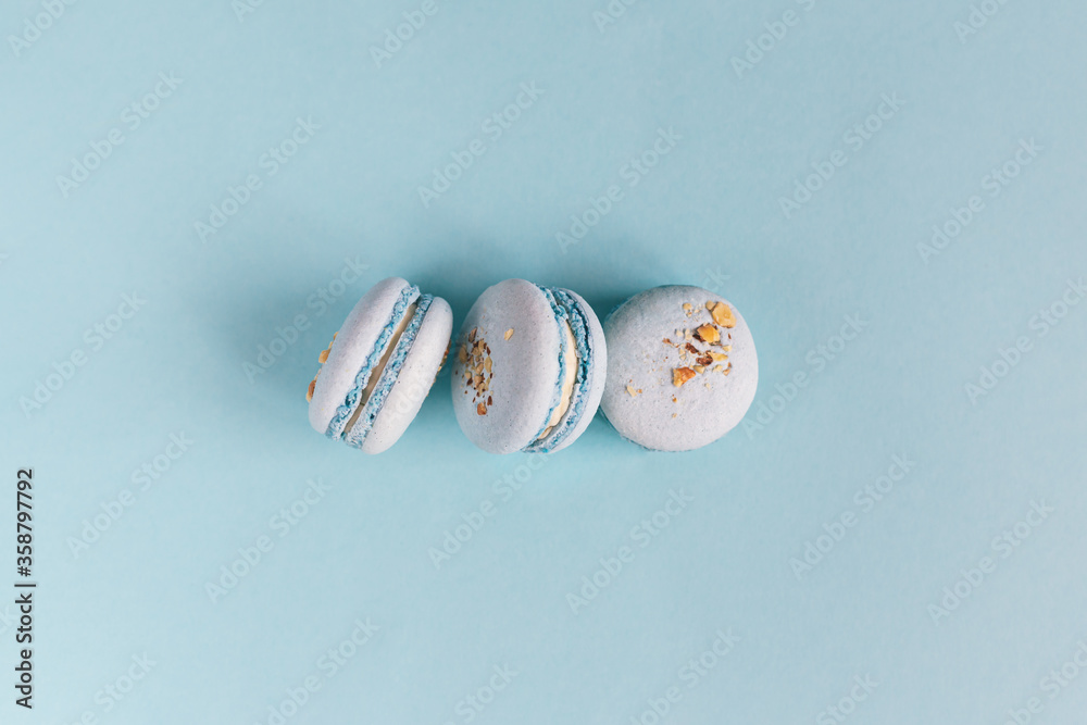 Tasty french macaroons on a light blue pastel background. Tasty french macaroons on a light blue pastel background.