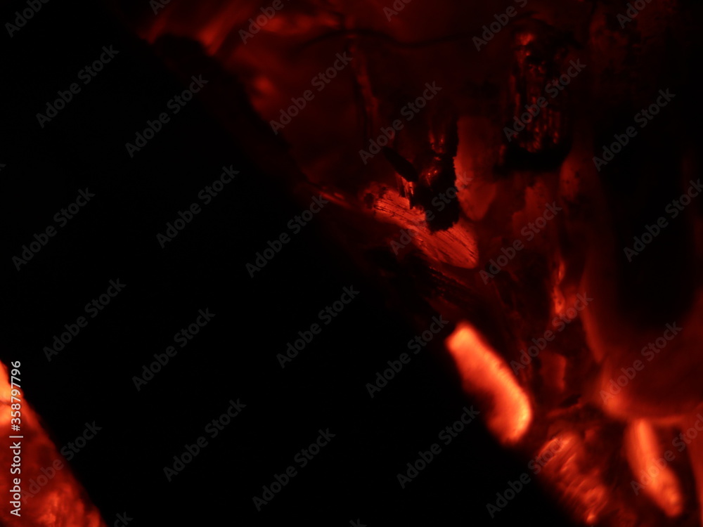 Fototapeta premium Close up shot of firewood burning in a fireplace-texture or background, abstract