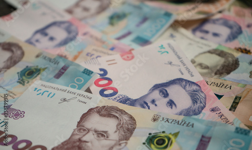 Banknote pattern from new Ukrainian money. Pile of New paper hryvnias different face value. Abstract blurred background or wallpaper. Close up shot.