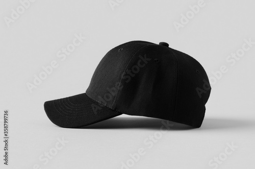 Canvas Print Black baseball cap mockup on a grey background, side view.