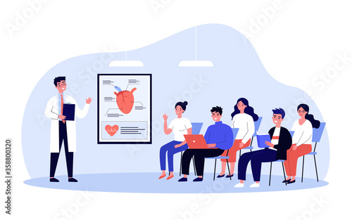 Medical college students listening to doctor lecture in classroom. Audience of young people classroom asking questions to speaker about heart surgery. For conference, seminar, education concept