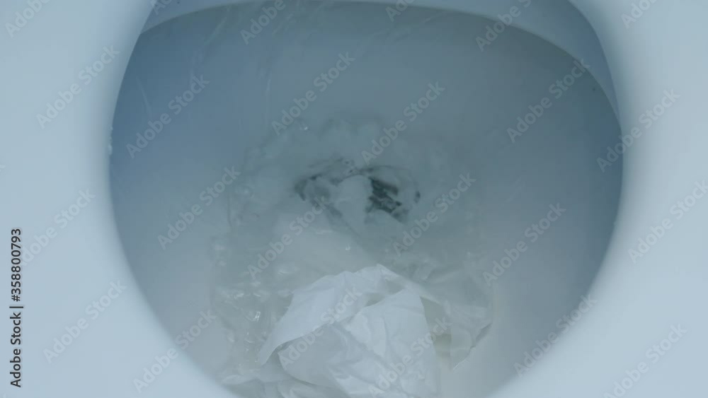 flushing of toilet tissue paper down a bathroom toilet