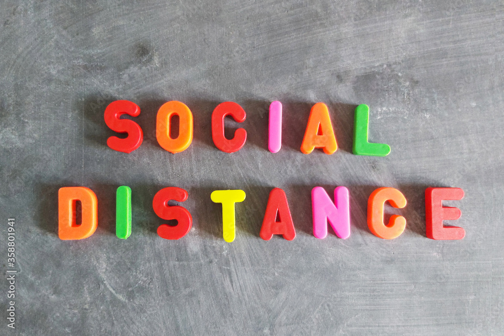 Social distance text in colorful letters on blackboard, horizontal