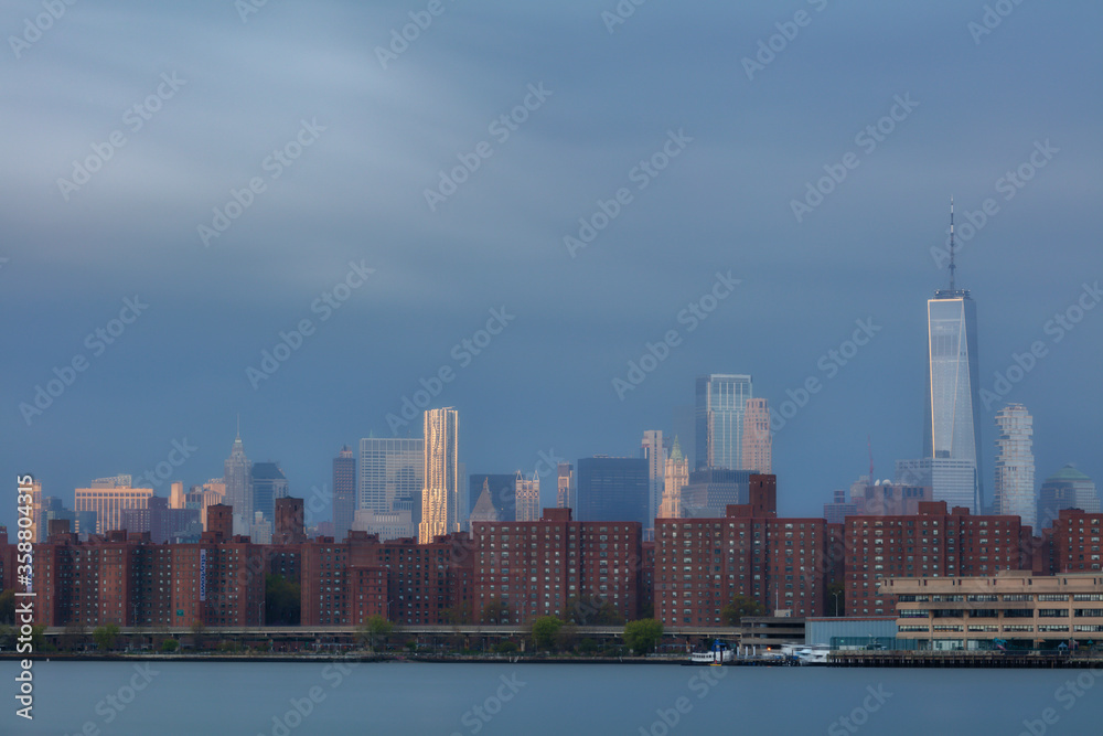 View on Lower Eastside from East River with long exposure at sunrise.