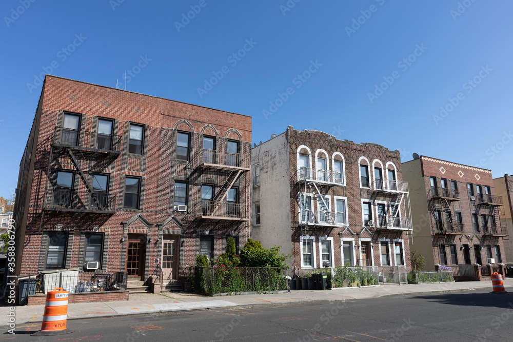 Row of Old Brick Residential Buildings along an Empty Street in Astoria Queens New York