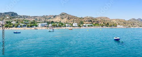Panoramic view of Stegna beach with anchored small boats (RHODES, GREECE)