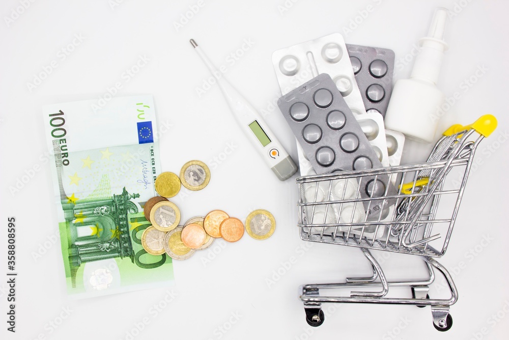 high costs of expensive medication concept. A stack of coins and banknotes and many pills in a shopping trolley or cart. Expensive medicine and treatment. online farmacy. Health care high costs of expensive medication concept. A stack of coins and banknotes and many pills in a shopping trolley or cart. Expensive medicine and treatment. online farmacy. Health care