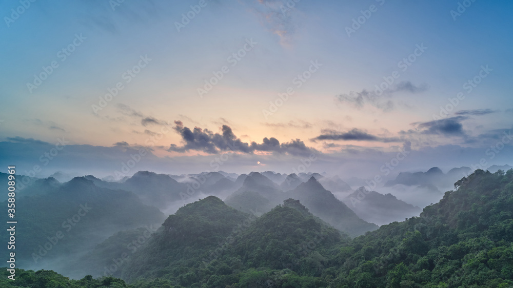 Panoramic view of the CatBa National Park, Vietnam. View from the top of the jungle hills of karst cliffs at dawn.