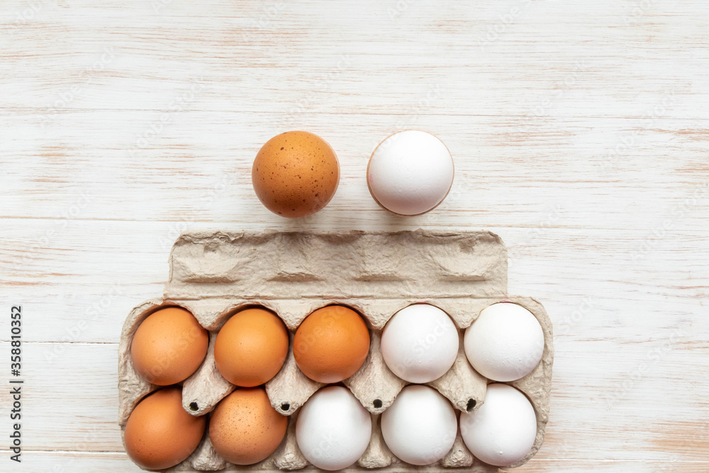 Free-range organic brown and white eggs in cardboard box Free-range organic brown and white eggs in cardboard box