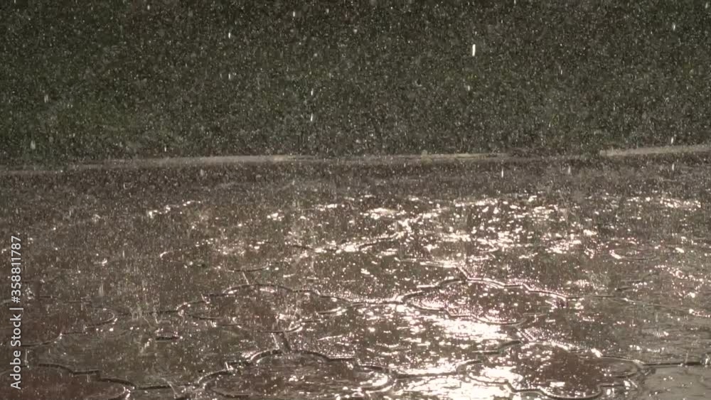 rain falls on the pavement slow motion