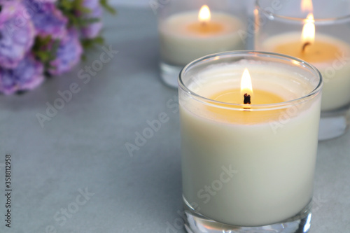 Картината върху платно The luxury lighting aromatic scented candle glass display on the grey table in t