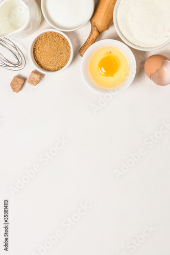 Baking ingredients at blue table top view.