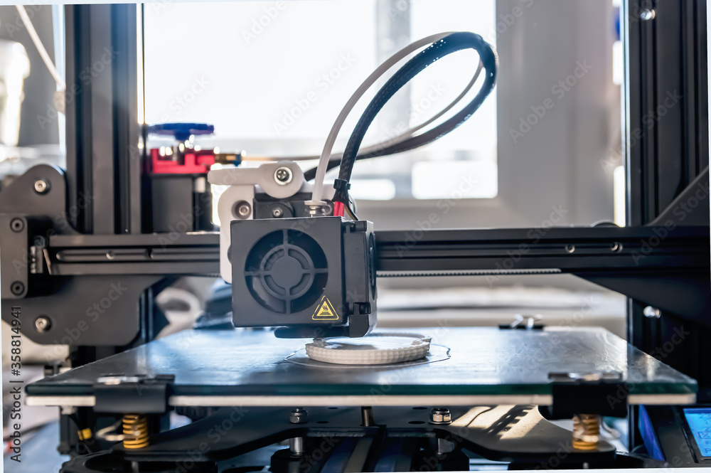 The 3D printer prints white plastic model The 3D printer prints white plastic model