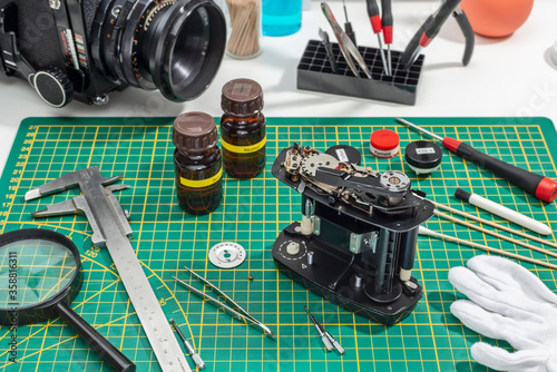 medium format film magazine dismantled on green background