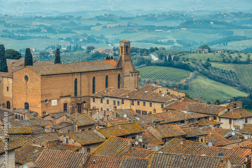 Chiesa di Sant'Agostino and the rooftops of the historic centre of San Gimignano seen from the Rocca di Montestaffoli at the Parco della Rocca. photo