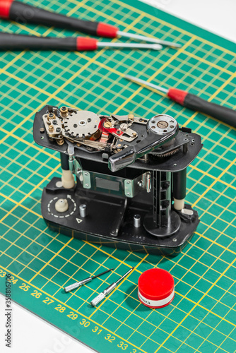 medium format film magazine dismantled on green background