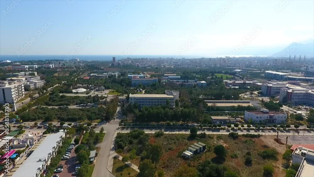 Buildings among the trees drone shot. City view from above. Buildings among the trees drone shot. City view from above.