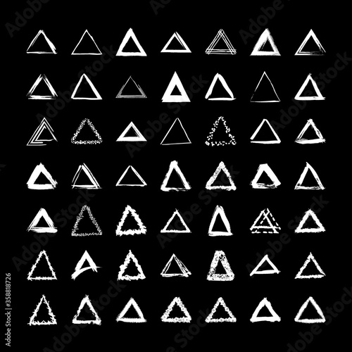 Collection of textured triangular frames isolated on black background. Set of white templates with splashes and spray in form square and rectangle in a dirty and freehand style.