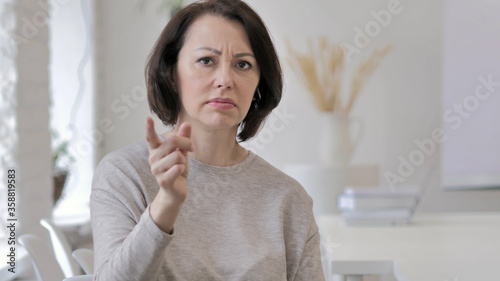 Angry Yelling Old Senior Woman Reacting to Problem at Work photo