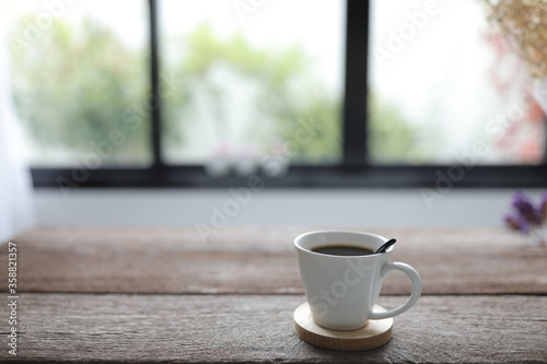 White coffee cup on rustic wooden dinning table interior home