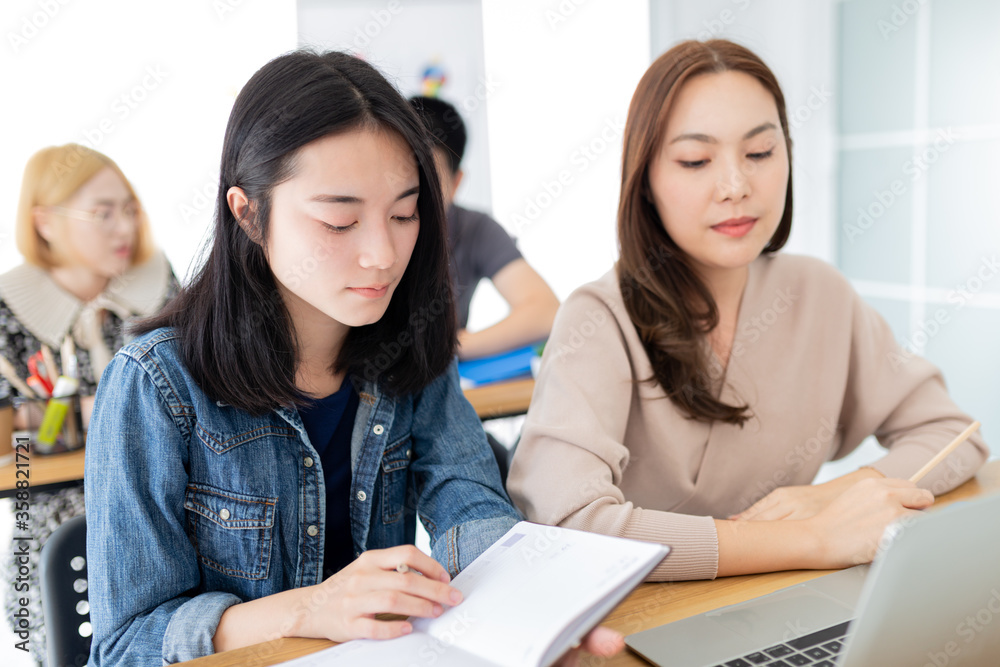 attractive asian female officer reviews literature and organization strategy, they sharing knowledge and learning to development, they feeling happy and smile, happiness organization attractive asian female officer reviews literature and organization strategy, they sharing knowledge and learning to development, they feeling happy and smile, happiness organization