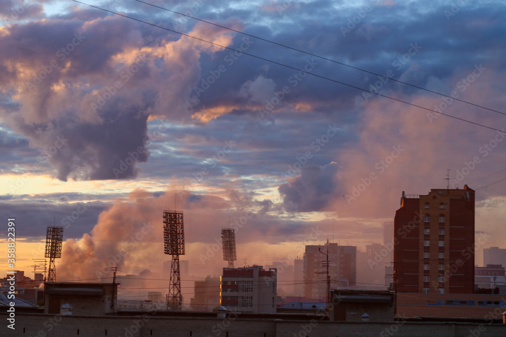 Fire in the Central market. A pillar of smoke rises over the city and buildings. The concept of a fire in the building Fire in the Central market. A pillar of smoke rises over the city and buildings. The concept of a fire in the building