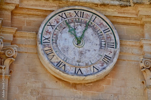 Historical clock on the Roman Catholic Cathedral of Saint Paul in main town square of Mdina village in Malta
