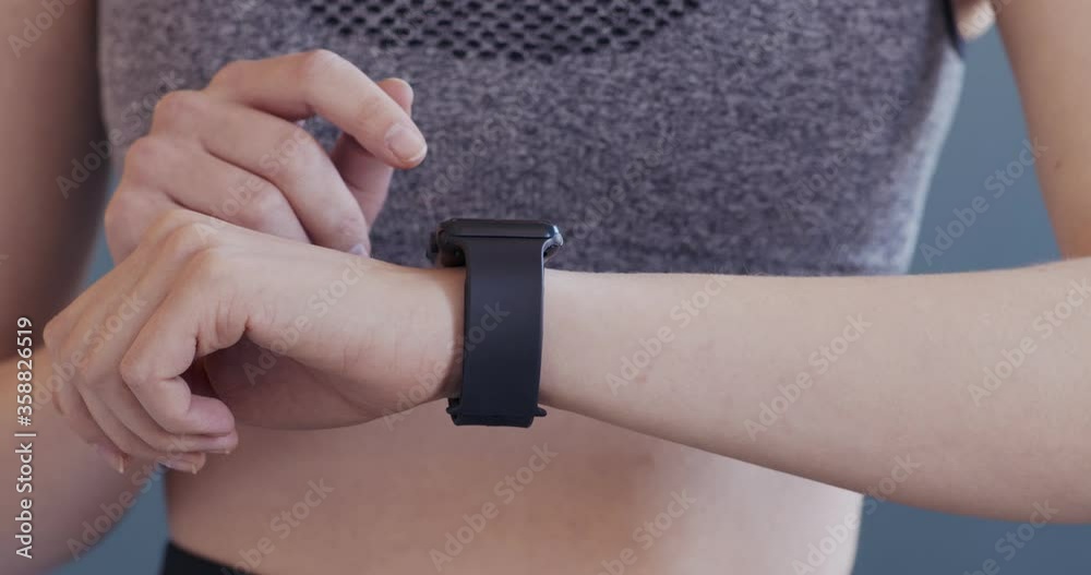 Fit girl using fitness bracelet before active workout, close up Fit girl using fitness bracelet before active workout, close up