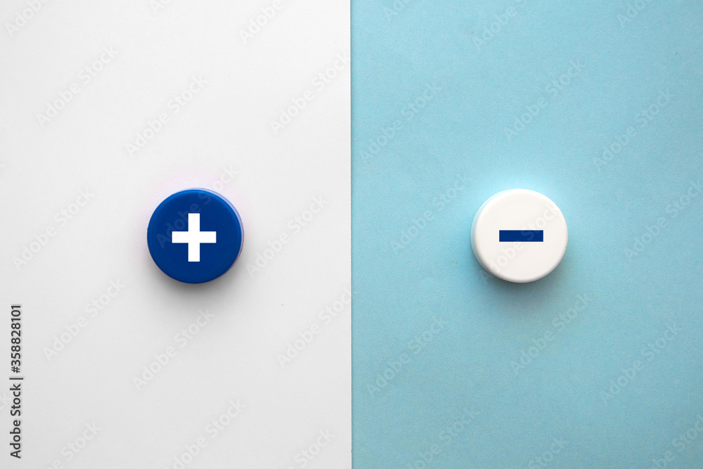 Plus and minus signs on a multi-colored background. Positive and negative information Plus and minus signs on a multi-colored background. Positive and negative information
