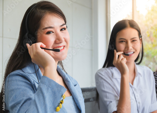 Professional call center woman advising a customer on the telephone.