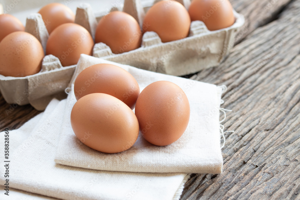 Chicken eggs, brown eggs, organic egg on calico at wooden rustic table. Natural eggs product concept. Chicken eggs, brown eggs, organic egg on calico at wooden rustic table. Natural eggs product concept.