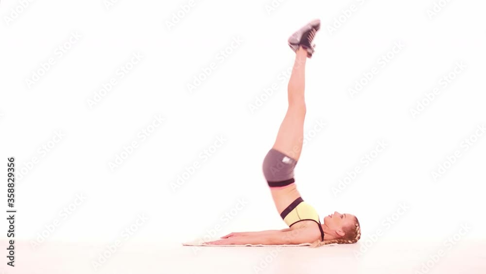 Fitness girl doing reverse crunch side view. Sports video tutorials isolated on white. Health care concept. Sports concept. tinted footage. Prores 422. Fitness girl doing reverse crunch side view. Sports video tutorials isolated on white. Health care concept. Sports concept. tinted footage. Prores 422.