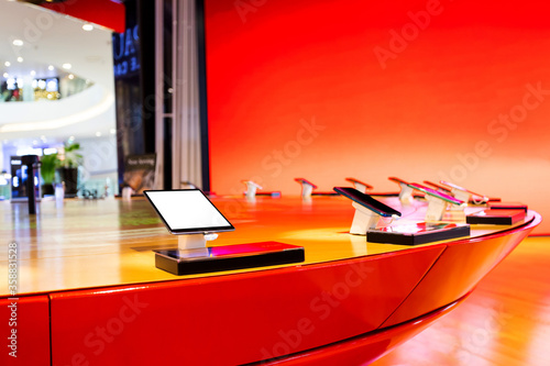 Demo smart phone and tablet on table for customes in phone shop photo